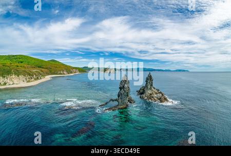Superbe paysage côtier au lever du soleil avec des formations rocheuses distinctes et des eaux océaniques claires Banque D'Images