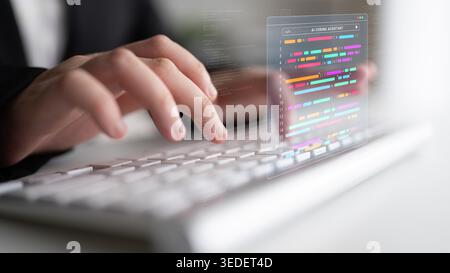 Un gros plan des mains tapant sur un clavier avec un affichage abstrait de code coloré représentant la programmation moderne et le développement de logiciels dans un élégant Banque D'Images
