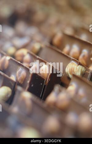 Tablettes de chocolat avec des noix disposées en rangées sur l'affichage Banque D'Images