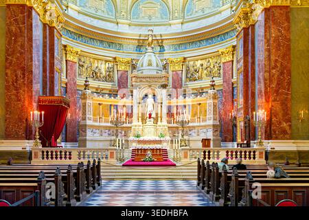 Les touristes explorent, la Basilique de Stephen à Budapest. L'intérieur a un grand autel et une belle architecture. Les visiteurs admirent l'art et le design. Banque D'Images