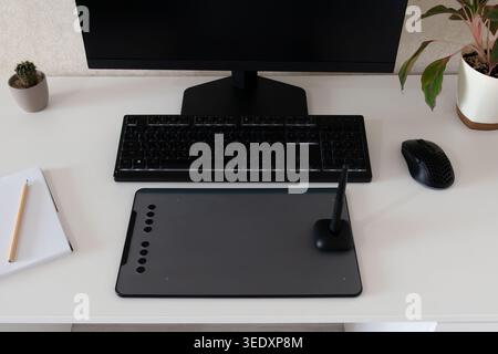 Vue de dessus de bureau à domicile propre avec tablette graphique de dessin, stylet, écran d'ordinateur, clavier, souris, cahier et plantes, concept d'art numérique Banque D'Images