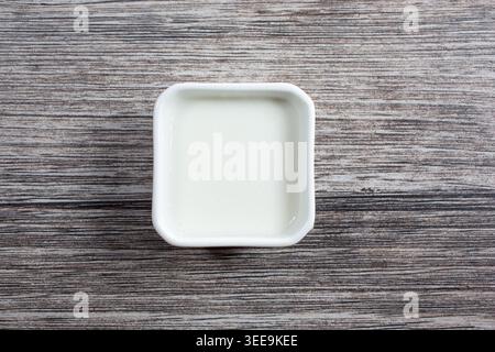 Une vue de haut en bas du toum dans un gobelet à condiments. Banque D'Images