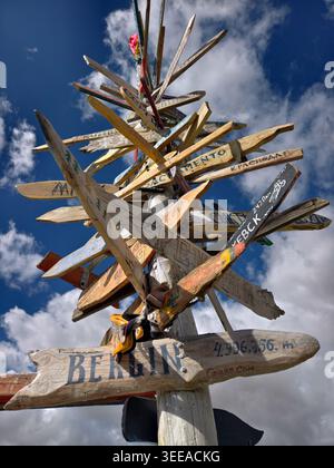 Altaï, Russie - 04 août 2025 : panneau de signalisation en bois sur fond de ciel bleu. Les flèches indiquent les directions vers diverses villes et géographies Banque D'Images