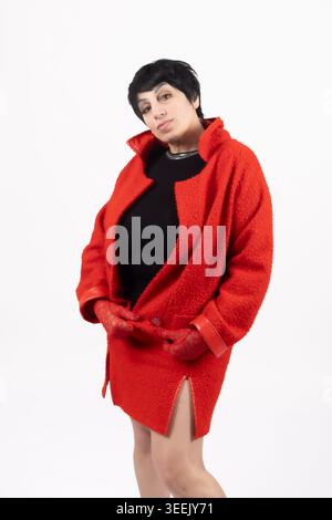 Femme enceinte en robe rouge posant vue de côté pour photograp stock professionnel... Banque D'Images
