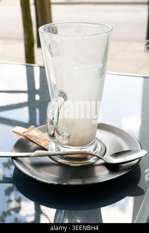 Verre Latte sale, bouchon de café vide, cappuccino fini, tasse vide avec restes de café et mousse Espuma Banque D'Images