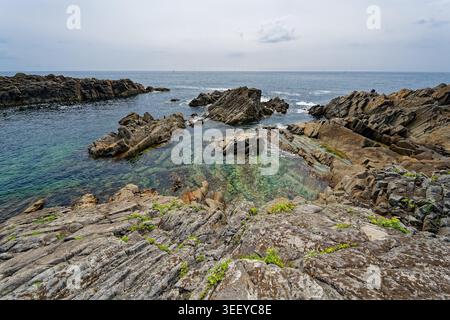 Crique rocheuse à l'eau bleue claire sur la côte française Banque D'Images