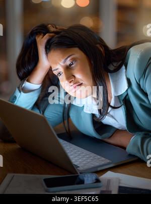 Ordinateur portable, nuit et fatigué avec une femme d'affaires au bureau pour brouillard cérébral, burnout ou fatigue. Ennuyé, ordinateur et délai avec employé épuisé au bureau Banque D'Images