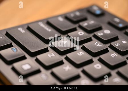 Vue latérale inclinée de dessus Macro Shot clavier noir mise au point d'Une touche avec arrière-plans techniques légèrement flous Banque D'Images