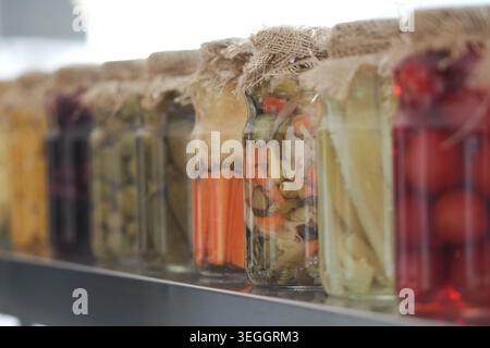Bouteilles de légumes marinés sur une étagère de cuisine Banque D'Images