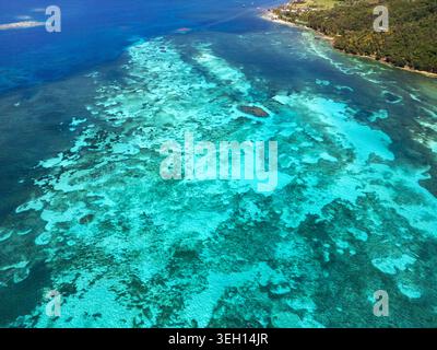 Vue aérienne des récifs coralliens turquoise et de la côte verdoyante de Guanaja, département des îles Bay, Honduras. Banque D'Images