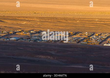 Vue aérienne de la ville de San Pedro de Atacama entourée par le vaste paysage aride du désert d'Atacama au coucher du soleil San Pedro de Atacama, Antofagast Banque D'Images