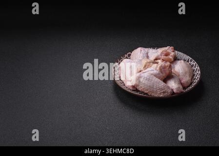 Nourriture, ailes de poulet crues, viande de volaille fraîche non cuite. Ailes de poulet ou de dinde avec sel et épices Banque D'Images