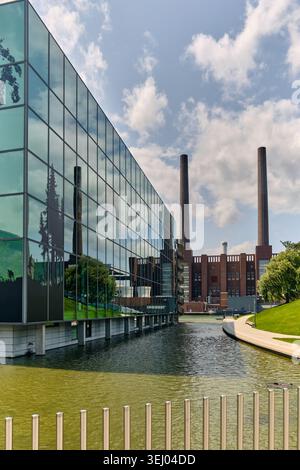 Wolfsburg, Allemagne - 06 juin 2025 : vue sur le musée Autostadt avec sa façade en verre moderne reflétant les environs et l'emblématique Volkswagen fac Banque D'Images