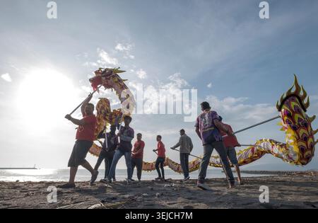 Les participants exécutent une danse du dragon traditionnelle lors de la célébration du Cap Go Meh à la plage de Teluk Penyu à Cilacap, Java central, Indonésie. Banque D'Images