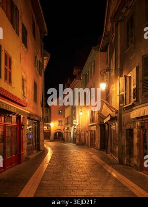 Annecy, France - 22.2023 : scène nocturne d'une rue calme dans la vieille ville avec des lampadaires vintage et un trottoir en pierre Banque D'Images