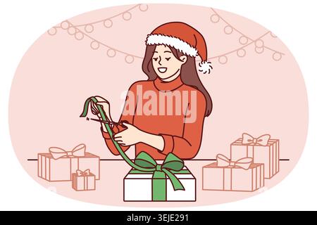 Femme de Noël fait des cadeaux de ses propres mains, se réjouissant à l'approche des vacances du nouvel an Banque D'Images