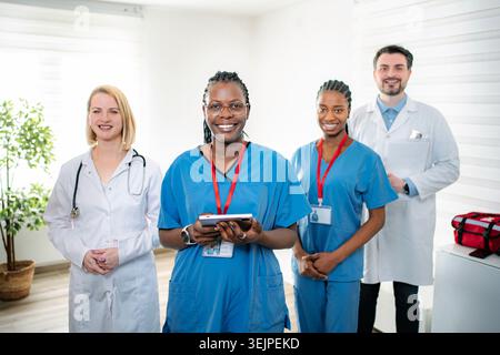 Divers professionnels de santé souriant ensemble en clinique Banque D'Images