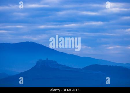 Spis Château ruines dominant une colline avec des montagnes au loin à l'heure bleue Banque D'Images