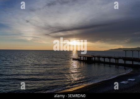 Coucher de soleil sur la mer : la rencontre du soleil et de l'eau. Banque D'Images