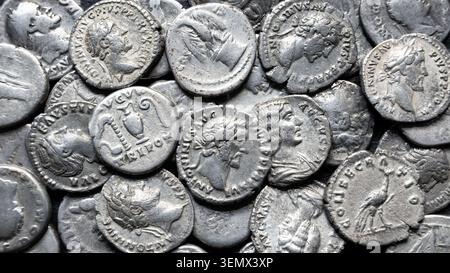 Gros plan, plan au-dessus du ciel, d'une collection de pièces d'argent anciennes empilées ensemble. Les pièces comportent des profils en relief détaillés de personnages historiques, Li Banque D'Images