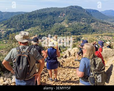 Groupe de randonnée sur un sentier de montagne avec guide regardant la vue sur la vallée de Valldemossa à Majorque Banque D'Images