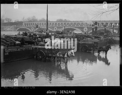 La Seine s'élève autour de la traversée de Bercy lors de l'inondation du 30 décembre 1919 dans une photographie de presse monochrome de l'Agence Rol. La source identifie la crue, Paris, la Seine, et le pont enregistré comme Pont de Tolbiac, c'est-à-dire Pont de Bercy. Banque D'Images