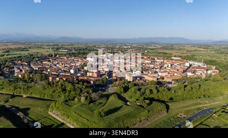 Vue aérienne de Palmanova, Italie, montrant la ville historique, les travaux de terrassement du fort étoilé, les remparts verts, les canaux, les champs, et des collines lointaines. Banque D'Images