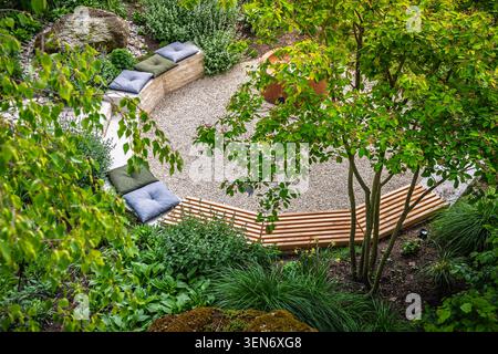 Coin salon minimaliste dans le jardin naturel, entouré de verdure Banque D'Images