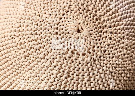 Gros plan de la texture de tissu tricoté beige avec un motif de crochet détaillé et un matériau en fil doux, le matériau en fil doux forme une surface complexe, idée Banque D'Images