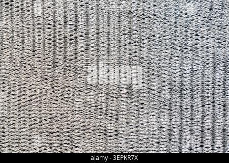 Une vue rapprochée d'une surface de tissu montrant un tissage complexe, une texture détaillée et un motif complexe, mettant l'accent sur l'artisanat et le matériau textile Banque D'Images