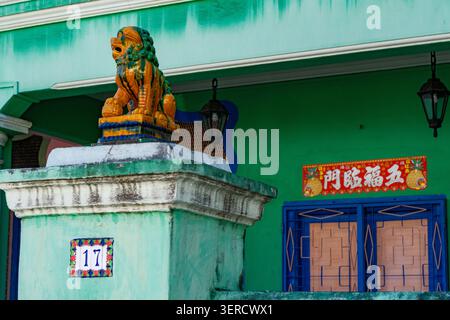 Façade traditionnelle Peranakan Heritage House dans le district de Katong Singapour avec mur vert et statue du lion gardien. Banque D'Images