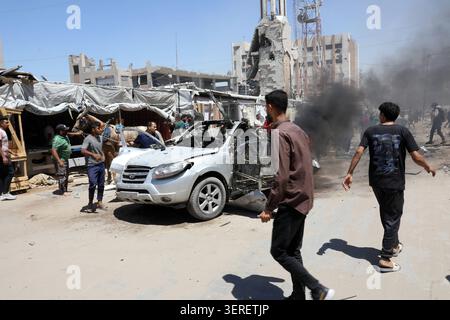 Les Palestiniens se rassemblent sur le site de la grève meurtrière de véhicules dans la ville de Gaza les Palestiniens et le personnel de la défense civile se rassemblent autour d’un véhicule détruit qui a été pris pour cible lors d’une frappe aérienne israélienne dans la ville de Gaza, le 18 juin 2026. La frappe a tué trois Palestiniens, selon des sources médicales, et a causé d'importants dégâts au véhicule. Photo de Belal Osama apaimages Gaza bande de Gaza territoire palestinien 180626 Gaza BO 1 005 Copyright : xapaimagesxBelalxOsamaxxapaimagesx Banque D'Images