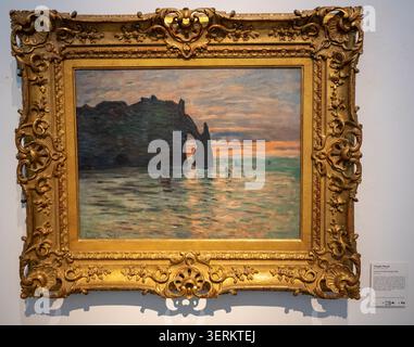 Nancy, France - 9 mars 25 : photographie d'un paysage marin encadré représentant une arche rocheuse côtière au coucher du soleil, exposée au Musée des Beaux-Arts de N. Banque D'Images