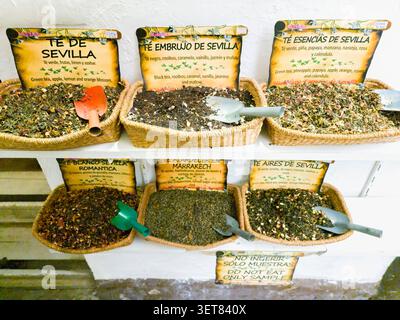 Un marché coloré avec des paniers remplis de mélanges de thé aromatisés et de plantes en vrac à Séville, en Espagne. Banque D'Images