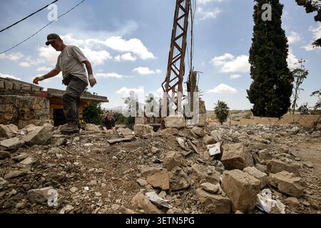 Mayfadoun, Mayfadoun, Liban. 23 juin 2026. Des hommes libanais travaillent à déblayer les décombres de leurs maisons détruites par les frappes aériennes israéliennes dans une zone du village dévasté de Mayfadoun, dans le sud du Liban. Des dizaines de Libanais qui avaient fui leurs villages ont commencé à rentrer pour faire face au choc dévastateur de voir leurs maisons complètement démolies. À la suite du récent accord américano-iranien, les résidents ont tenté de rentrer, mais ont été accueillis par des scènes de gravats et de cendres. (Crédit image : © Marwan Naamani/ZUMA Press Wire) USAGE ÉDITORIAL SEULEMENT ! Non destiné à UN USAGE commercial ! Banque D'Images