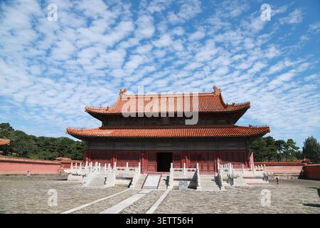 Cette majestueuse salle à double paroi des tombeaux Qing orientaux présente une architecture impériale chinoise traditionnelle avec des murs rouges éclatants et des rouloirs orangés dorés Banque D'Images