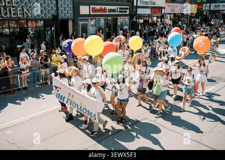 Toronto, Canada - 29 juin 2025 : enfants portant des ballons et une bannière Banque D'Images