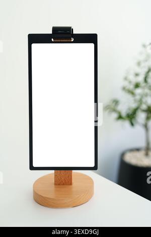 Présentoir en bois de menu vide moderne avec cadre noir pour personnaliser au café blanc intérieur Banque D'Images