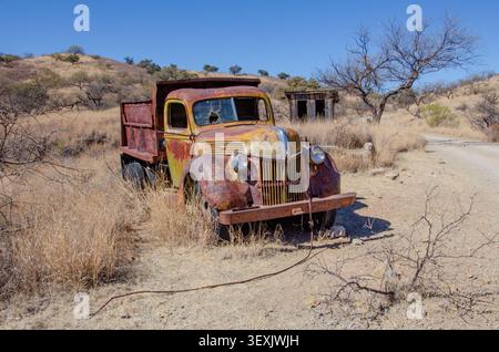 Un vieux camion à benne basculante abandonné Ford rouille le long du chemin de terre dans la ville fantôme minière de Ruby, Arizona Banque D'Images