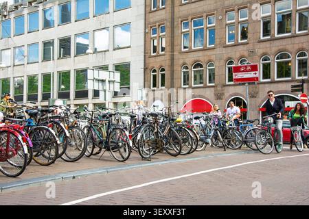 Amsterdam, pays-Bas. 22 juin 2014, rue Amsterdam avec de nombreux vélos garés le long des bâtiments Banque D'Images