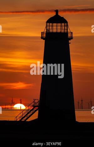 Plan vertical spectaculaire du phare de la pointe d'Ayr sur un ciel de coucher de soleil rouge profond et or brillant, Talacre Beach Banque D'Images