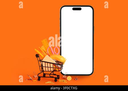 Smartphone avec écran vierge et panier rempli de fournitures de bureau Orange Banque D'Images