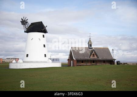Le moulin blanc historique de Lytham Windmill se dresse sur Lytham Green aux côtés du musée de la maison des canots de sauvetage à Lytham St Annes, dans le Lancashire. Banque D'Images