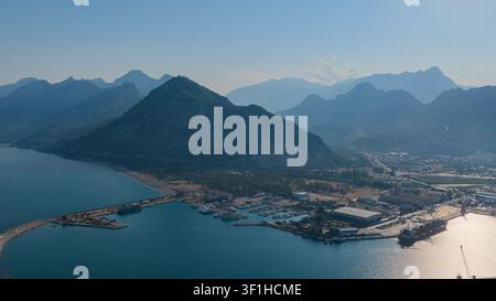 Une vue panoramique depuis les hauteurs sur le spacieux port et la marina nichés au pied de montagnes majestueuses. Un mélange de nature et d'industrie. Banque D'Images