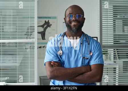 Portrait d'un vétérinaire masculin noir souriant dans une clinique vétérinaire Banque D'Images