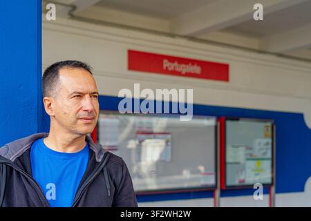 Un homme européen blanc portant une chemise bleue arrive à la gare de Portugalete. Banque D'Images