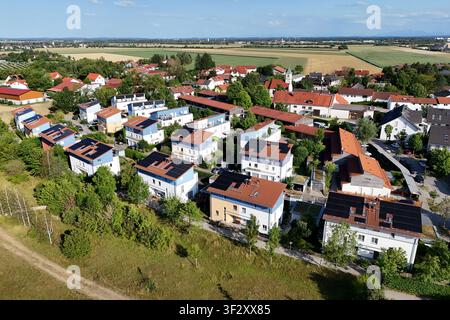 La photographie aérienne montre plusieurs maisons individuelles et maisons mitoyennes dans un lotissement moderne avec des systèmes photovoltaïques à grande échelle sur les toits. Les modules solaires utilisent une grande partie des surfaces des toits pour une production d'énergie durable Banque D'Images