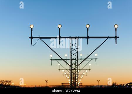 Lumières de la piste d'atterrissage de l'aéroport au coucher du soleil Banque D'Images