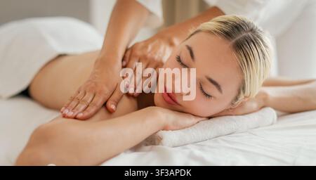 Femme recevant un massage des épaules au Cozy Spa Banque D'Images