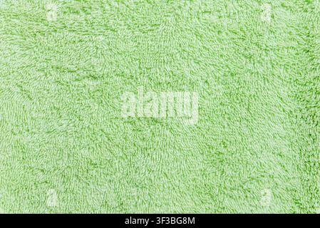 Fond texturé en coton vert pastel frais avec espace pour du texte. Fond texturé en tissu éponge vert clair avec espace de copie. Banque D'Images